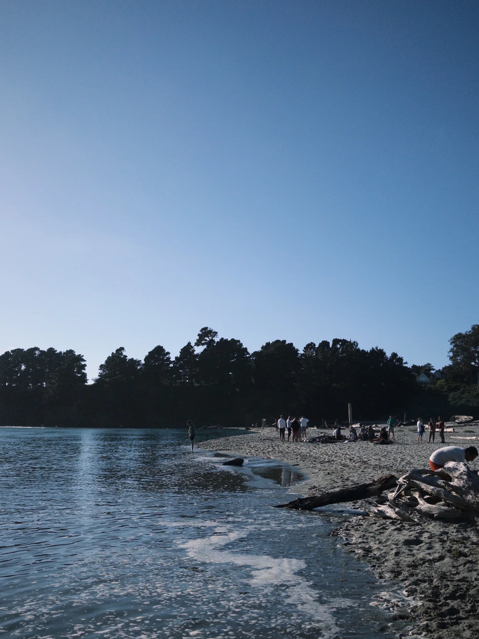 The beach after the tide, people in the distance