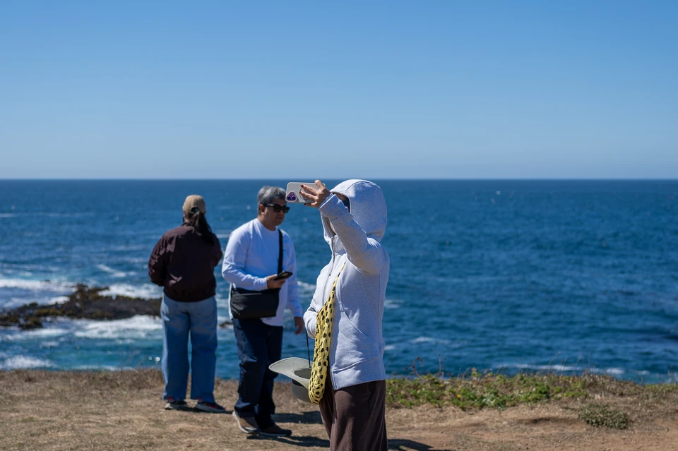 Three people at the cliff edge