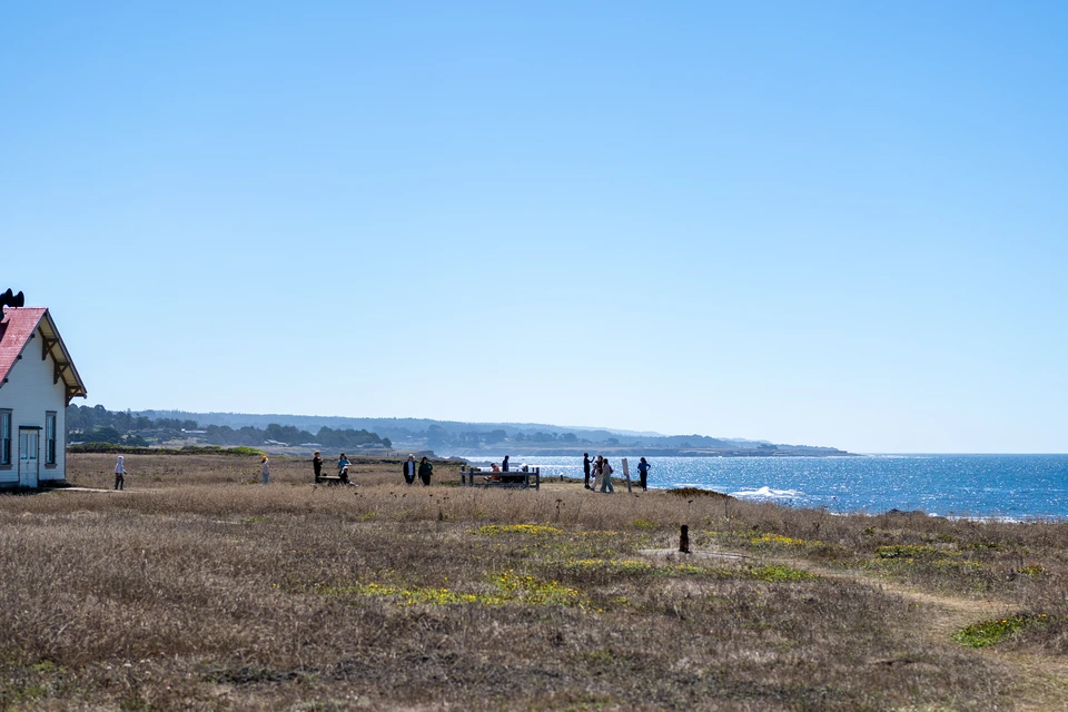 The light station on the headland, people walking