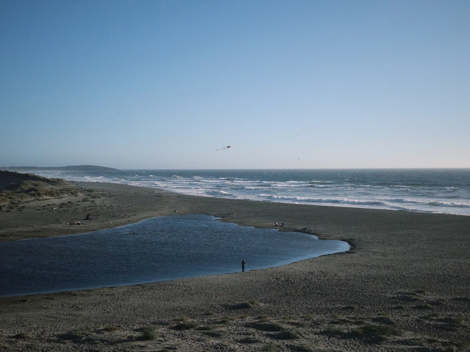 A creek crossing the beach at dusk