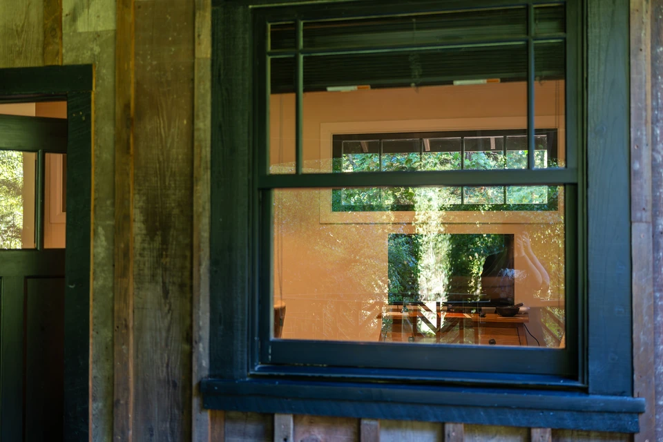 The cabin's green-painted door and window