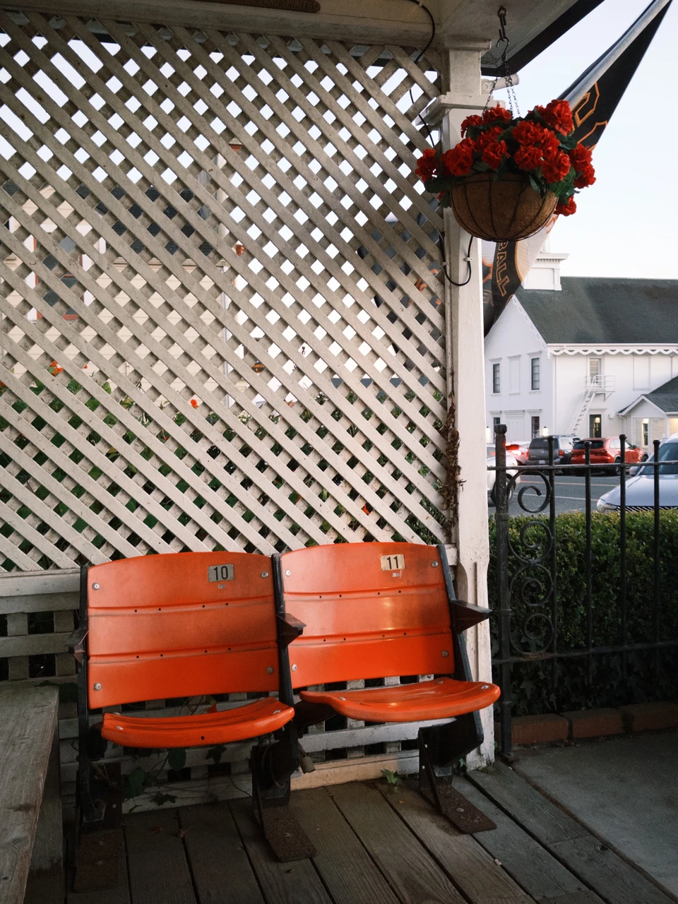 Two orange chairs on a porch