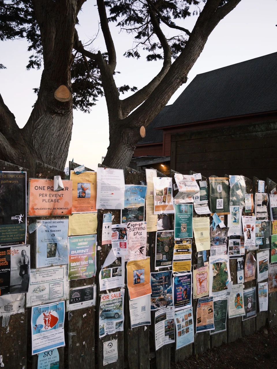 A community board layered with local flyers